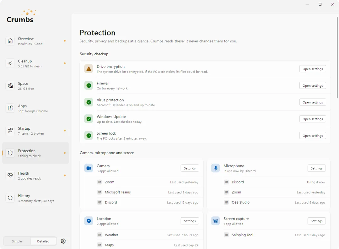 The Protection screen on Windows 11: a security checkup that flags the drive as not encrypted and shows the firewall, virus protection, Windows Update and screen lock as fine, each with an Open settings button, above lists of which apps can use the camera and microphone.
